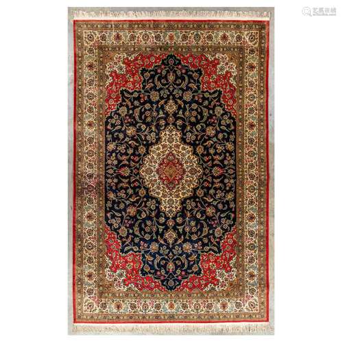 An Oriental hand-made carpet made of silk, decorated with bi...