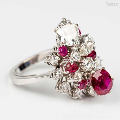 A ring with diamonds and red stones, with a total weight of ...