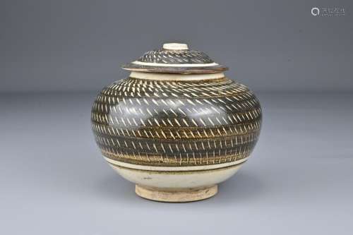 A Chinese 'rouletted' pottery jar and cover. The o...