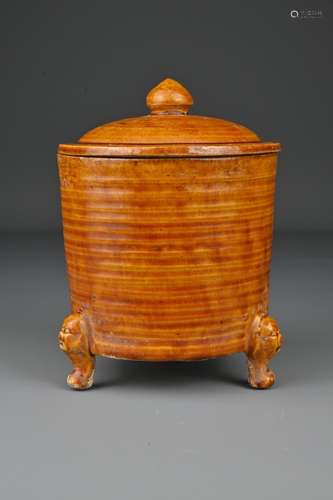 A Chinese amber-glazed tripod pottery jar and cover.