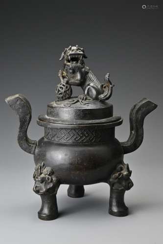 A Chinese Ming dynasty bronze tripod censer and cover.