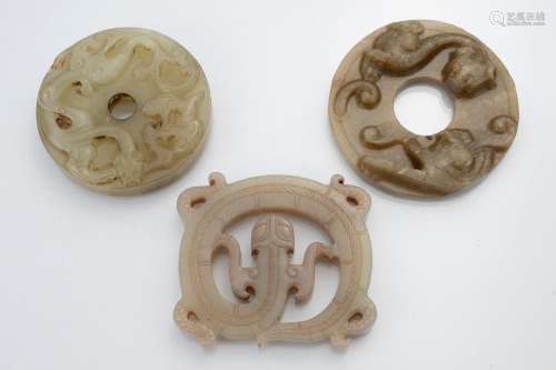 Two Chinese Bi disc form jade pendants each carved with