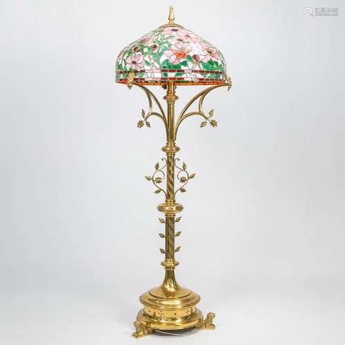 A large standing lamp made of copper with a Tiffany style la...