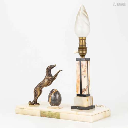 A lamp with a dog and marble egg, made of onyx and bronze, a...