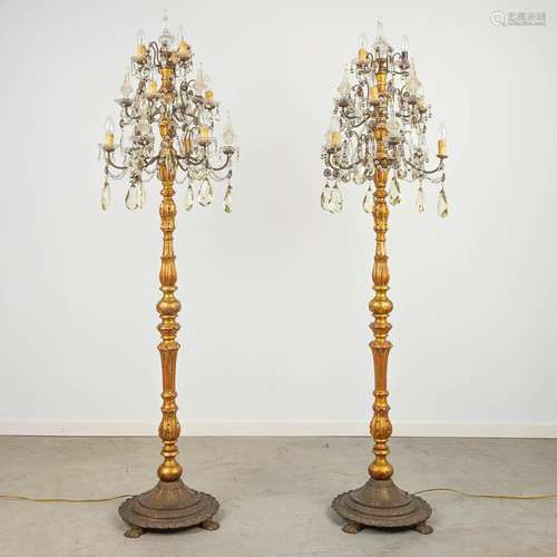 A pair of sculptured wood floor lamps or standing lamps made...