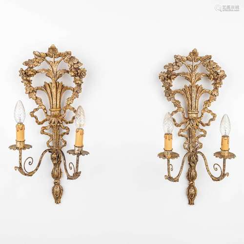 A pair of gilt wall lamps made of sculptured wood and stucco...