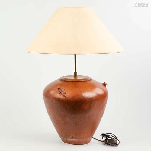 A table lamp made of terracotta and decorated with salamande...