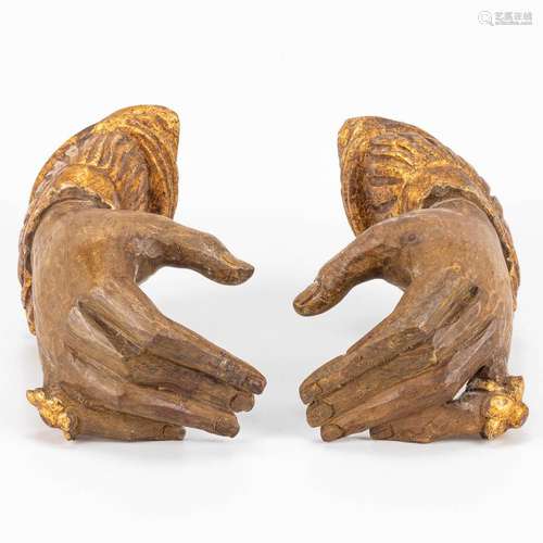 A pair of wood sculptured hands.