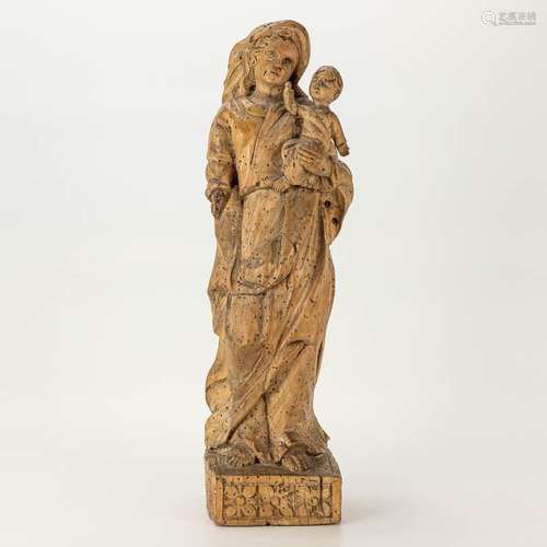 A wood sculptured Madonna with child. The first half of the ...