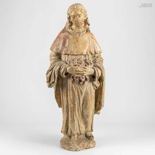 A statue made of stone with traces of the original polychrom...