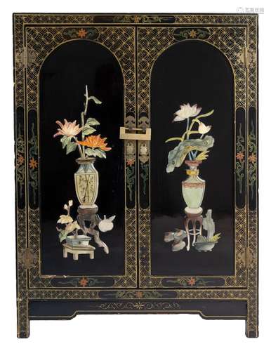 A Chinoiserie black lacquer cabinet with raised and