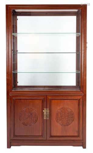 A Chinese carved hardwood glazed display cabinet with