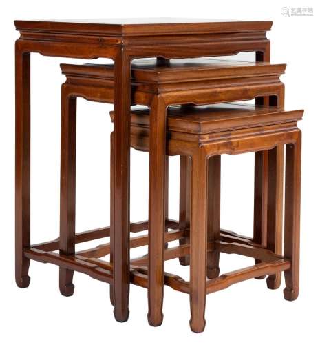 A Chinese hardwood nest of three side tables with