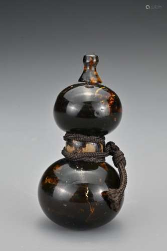 A Japanese amber and horn netsuke in the form of a