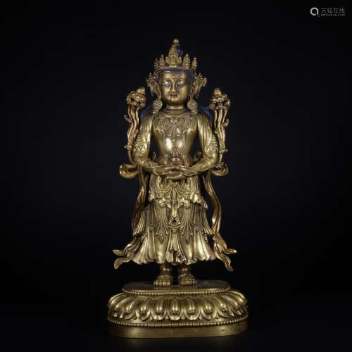 A gilt-bronze standing buddha