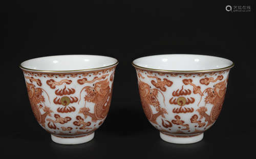 A pair of allite red glazed 'dragon' cup