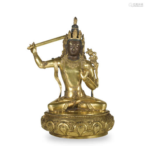 A gilt-bronze statue of Manjusri