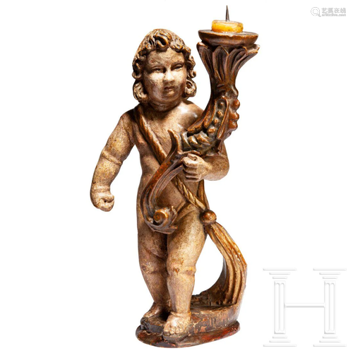 A carved southern German Angel with candelabra, circa