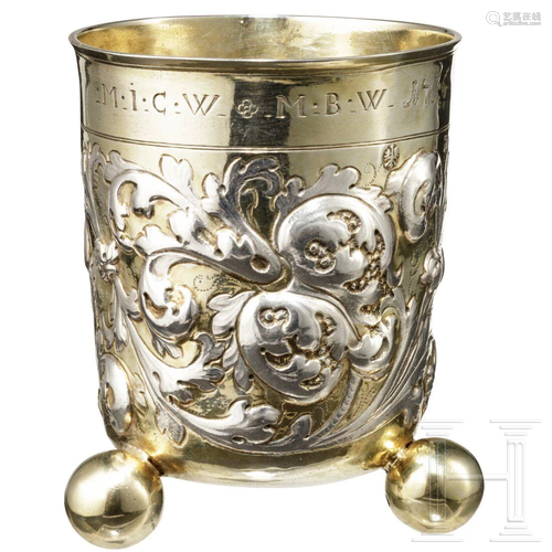 A silver, partially gilded beaker on spherical feet,