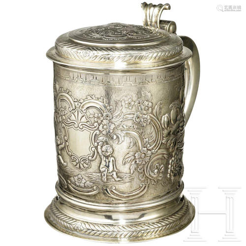 A German floral and ornamental embossed silver tankard,