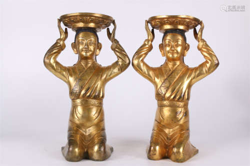 A Gilt Copper Kneeing Man Candle Stick.