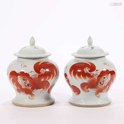 A Pair of Iron Red Glaze Lion Group Ginger Jars and Covers