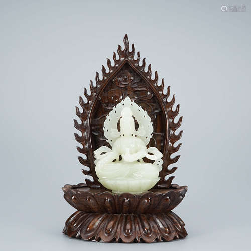 A Carved White Jade Figure of Seated Buddha