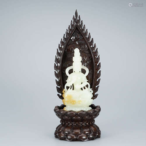 A Carved White and Russet Jade Guanyin with Stand