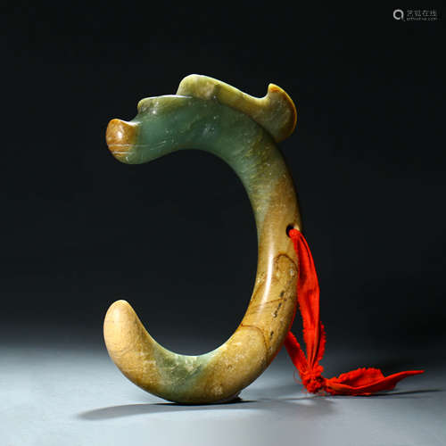 A Carved Greenish Jade C-Form Dragon Pendant