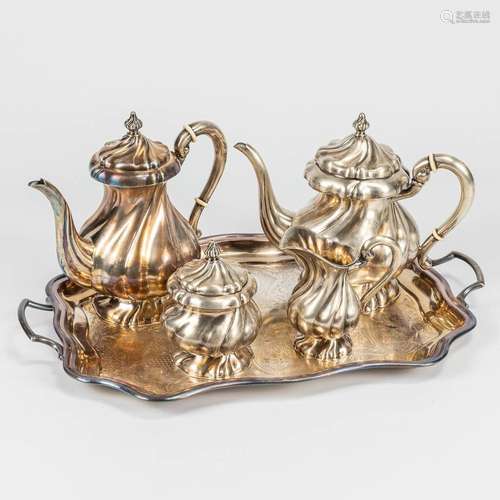 A 4-piece coffee and tea service made of silver on a silver-...