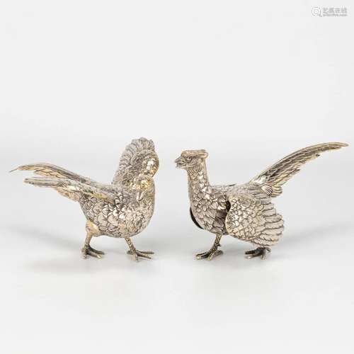 A collection of 2 pheasants made of silver.