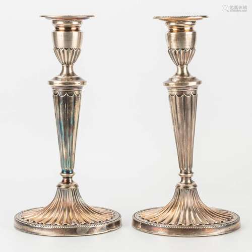 A pair of silver candlesticks marked DJS, D J Silver Repairs...