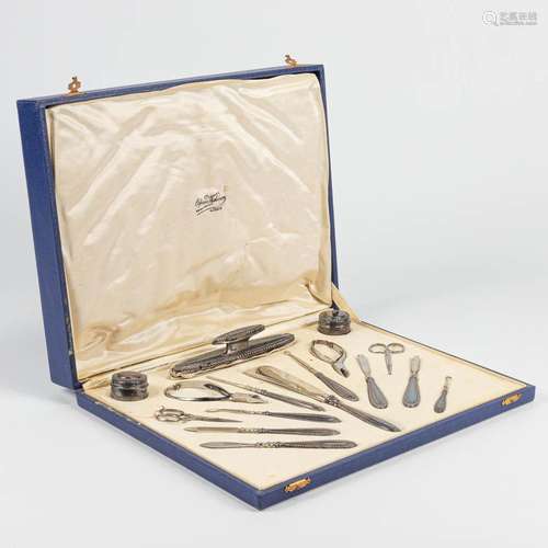 A large silver-plated manicure set in the original box and m...