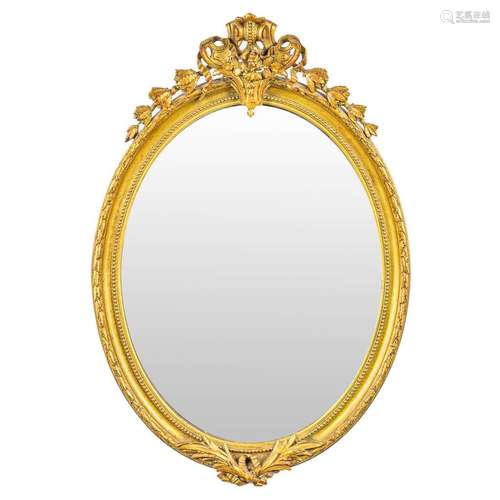 An antique and oval mirror in Louis XVI style