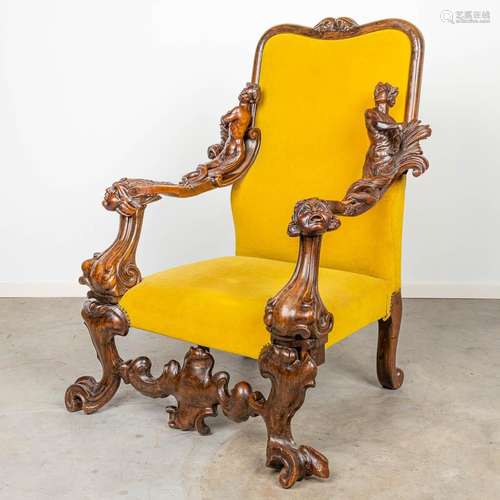 An armchair with richly decorated armrests in the style of A...