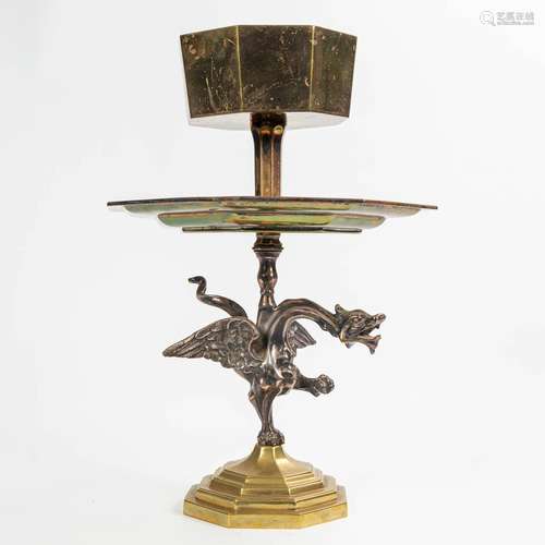 A side table or plant stand made of brass and decorated with...