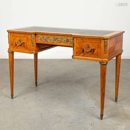 A desk mounted with bronze and made in Louis XVI style.