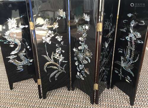 Asian lacquer table screen with mother of pearl decoration.