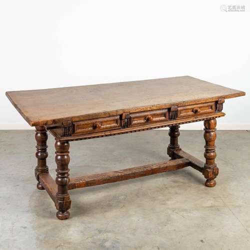 An antique table with 6 drawers, made during the 17th centur...