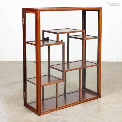 An Oriental display cabinet made of hardwood and glass.