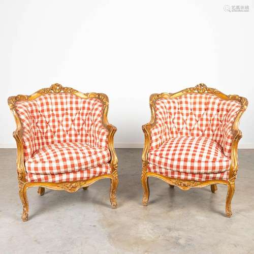 A pair of armchairs made of gilt sculptured wood in Louis XV...