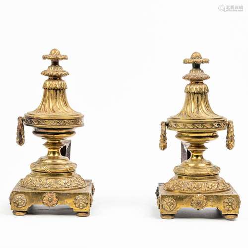 A pair of fireplace andirons made of bronze and metal in Lou...