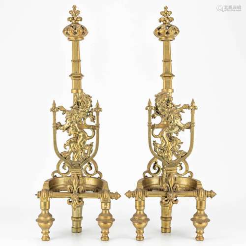 A pair of fireplace andirons made of bronze and decorated wi...