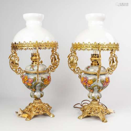 A pair of oil lamps with opaline glass shades mounted with b...