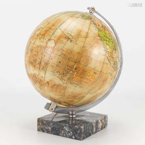 A globe made of glass on a marble base and made in France.