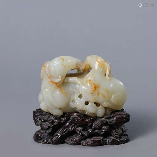 A Carved Russet and White Jade Three Rams Ornament