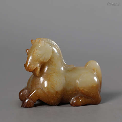 A Carved Russet and White Jade Horse Ornament