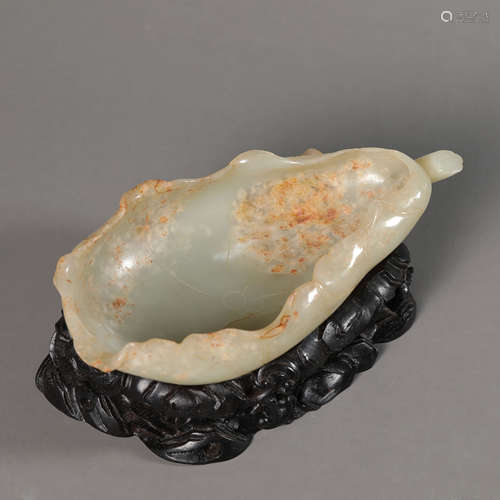 A Carved Russet and White Jade Lotus-Petal Shape Washer