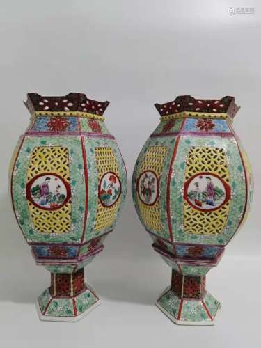 A pair of pastel colored six-sided candle stand lanterns