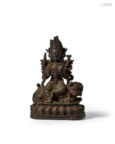 A Bronze Seated figure of Manjusri atop a lion